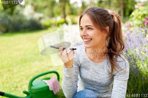 Image of gardener recording voice message by smartphone