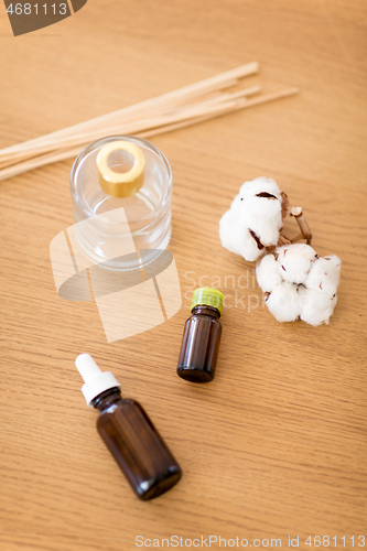 Image of aroma reed diffuser, essential oil and cotton flower