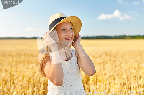 Image of portrait of girl in straw hat on field in summer