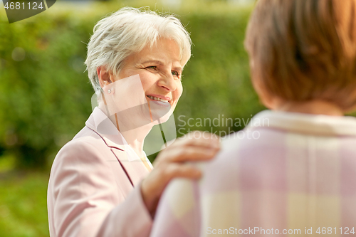 Image of senior women or friends talking at summer park