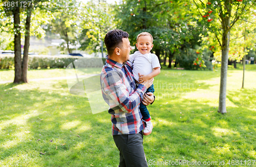 Image of happy father with little son in summer park