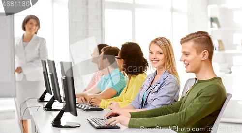 Image of happy high school students in computer class