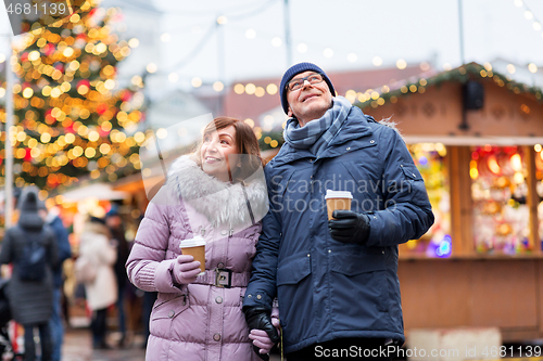 Image of senior couple with coffee at christmas market