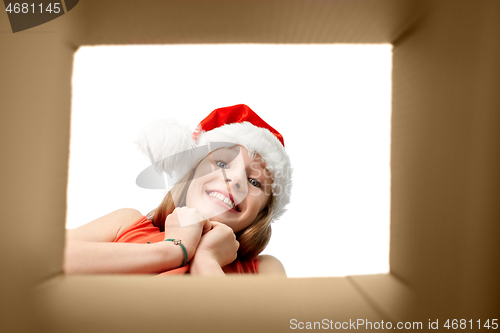 Image of amazed girl looking into christmas gift box