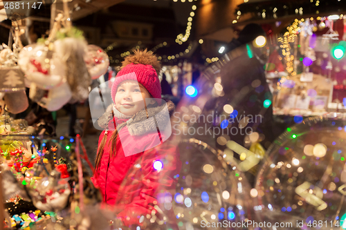 Image of girl choosing christmas decorations at market
