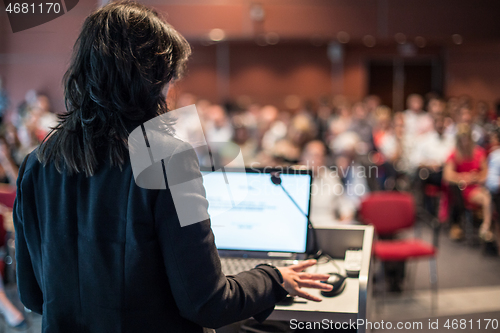 Image of Public speaker giving talk at Business Event.