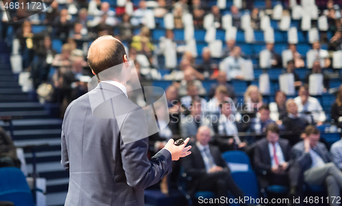 Image of Public speaker giving talk at Business Event.