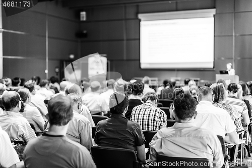 Image of Woman giving presentation in lecture hall at university.