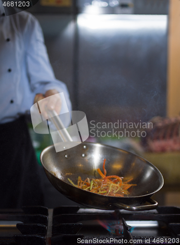 Image of Chef doing flambe on food