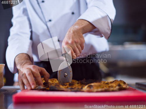 Image of chef cutting baked bread