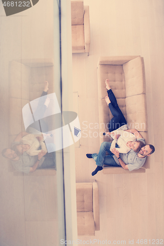 Image of romantic couple on the sofa watching television top view