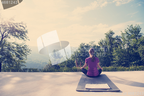 Image of handsome woman doing morning yoga exercises