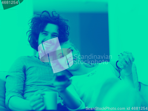 Image of Young couple on the sofa watching television