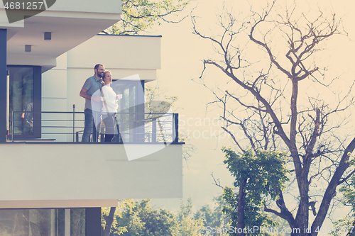 Image of couple enjoying morning coffee on balcony