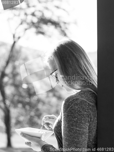 Image of woman eating breakfast in front of her luxury home villa