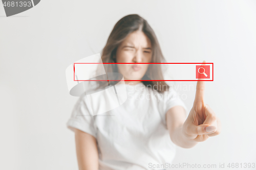 Image of Woman\'s hand with finger on gray background