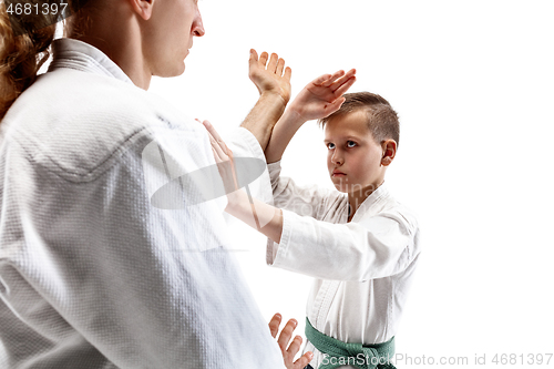 Image of Man and teen boy fighting at aikido training in martial arts school