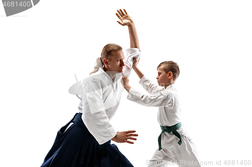 Image of Man and teen boy fighting at aikido training in martial arts school