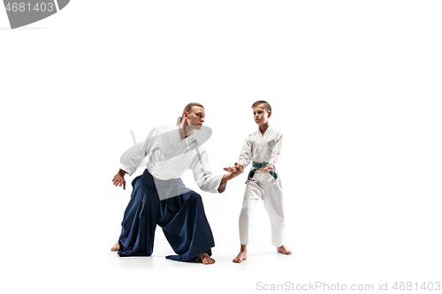 Image of Man and teen boy fighting at aikido training in martial arts school