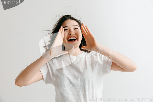 Image of Isolated on pink young casual woman shouting at studio