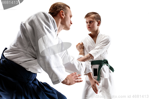 Image of Man and teen boy fighting at aikido training in martial arts school