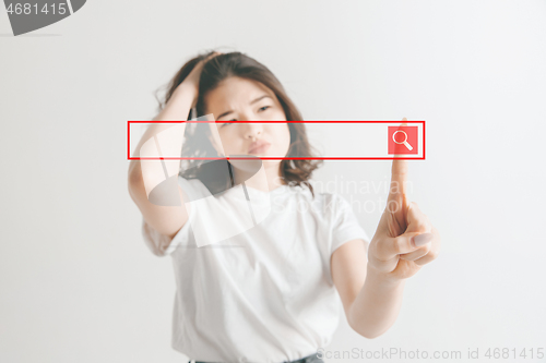 Image of Woman\'s hand with finger on gray background