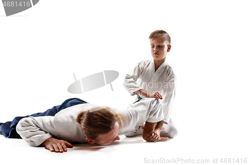 Image of Man and teen boy fighting at aikido training in martial arts school