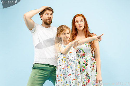 Image of Happy parent with daughter at studio isolated on blue background