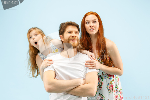 Image of Happy parent with daughter at studio isolated on blue background