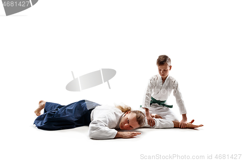 Image of Man and teen boy fighting at aikido training in martial arts school