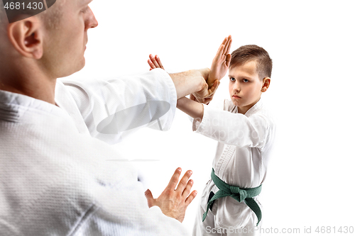 Image of Man and teen boy fighting at aikido training in martial arts school