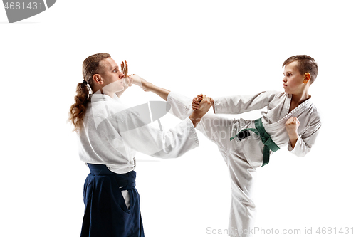 Image of Man and teen boy fighting at aikido training in martial arts school