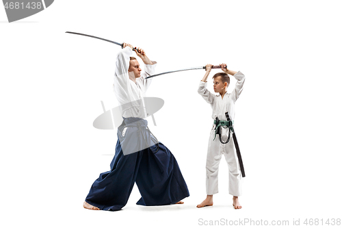 Image of Man and teen boy fighting at aikido training in martial arts school