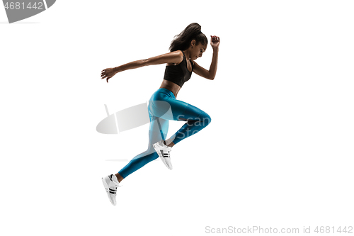 Image of Young african woman running or jogging isolated on white studio background.