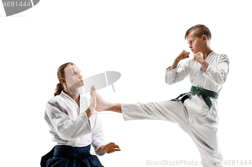 Image of Man and teen boy fighting at aikido training in martial arts school