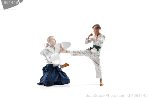 Image of Man and teen boy fighting at aikido training in martial arts school