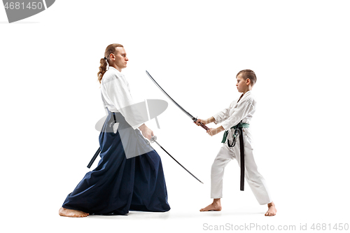 Image of Man and teen boy fighting at aikido training in martial arts school