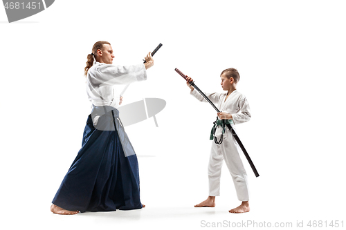 Image of Man and teen boy fighting at aikido training in martial arts school