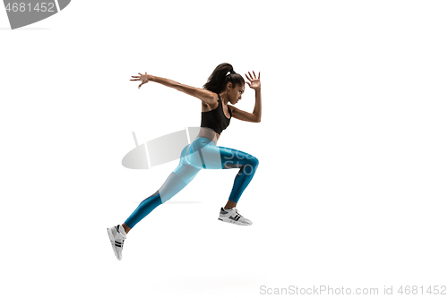 Image of Young african woman running or jogging isolated on white studio background.