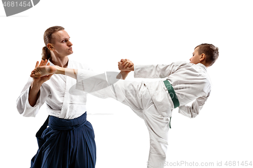 Image of Man and teen boy fighting at aikido training in martial arts school