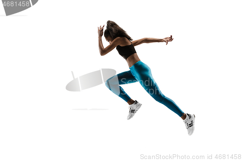 Image of Young african woman running or jogging isolated on white studio background.