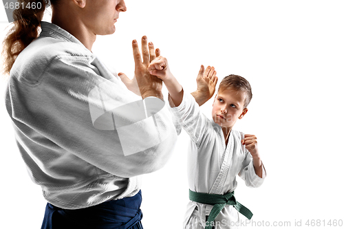 Image of Man and teen boy fighting at aikido training in martial arts school