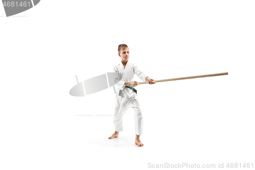 Image of Teen boy fighting with wooden swords at Aikido training in martial arts school