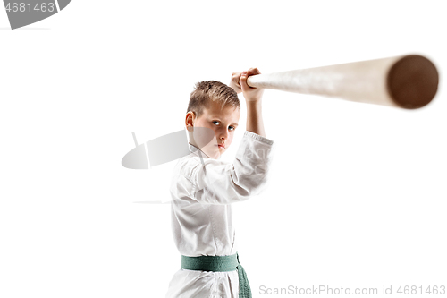 Image of Teen boy fighting with wooden sword at Aikido training in martial arts school