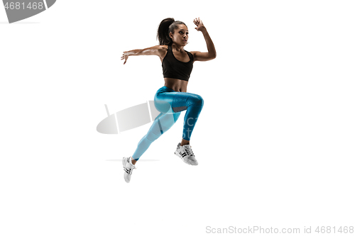 Image of Young african woman running or jogging isolated on white studio background.