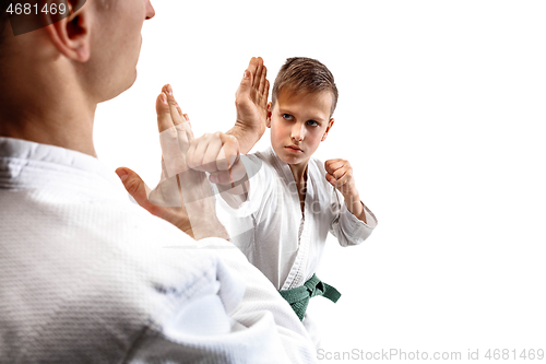 Image of Man and teen boy fighting at aikido training in martial arts school