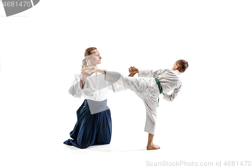 Image of Man and teen boy fighting at aikido training in martial arts school