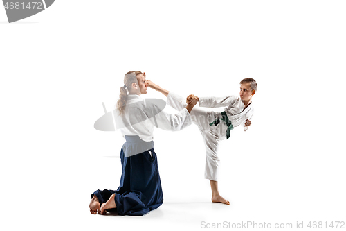 Image of Man and teen boy fighting at aikido training in martial arts school