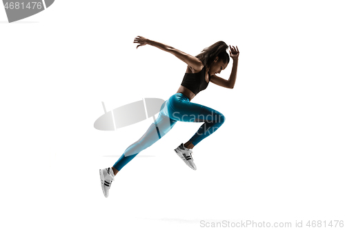 Image of Young african woman running or jogging isolated on white studio background.