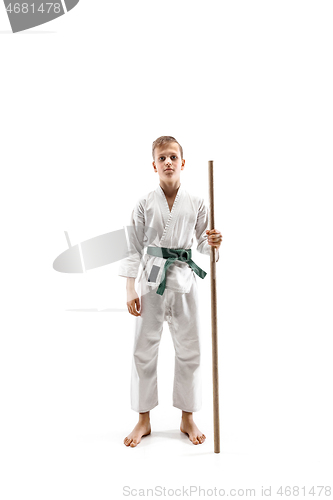 Image of Teen boy fighting with wooden sword at Aikido training in martial arts school